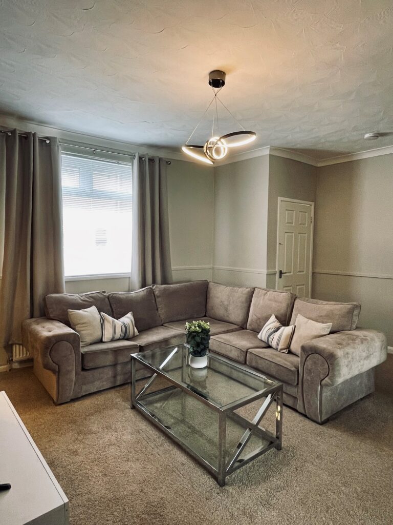 Beige living room with blue feature wall and black coffee table