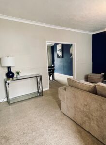 Beige living room with blue feature wall and black coffee table