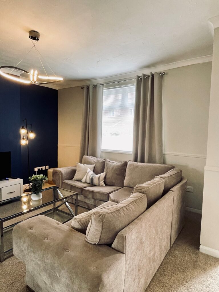 Beige living room with blue feature wall and black coffee table