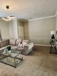 Beige living room with blue feature wall and black coffee table