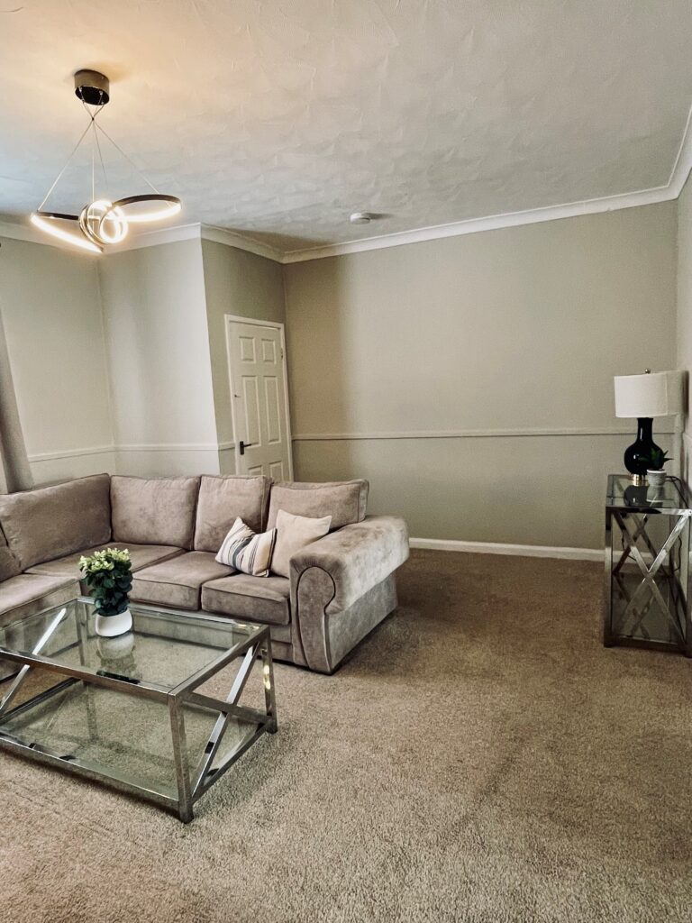 Beige living room with blue feature wall and black coffee table