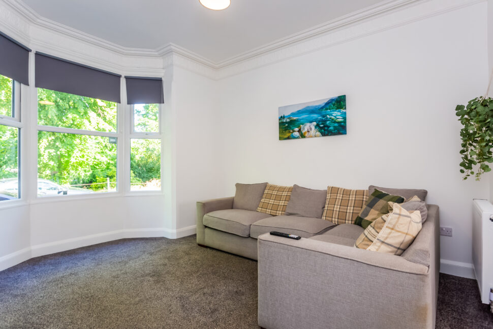 Off white living room with grey sofas