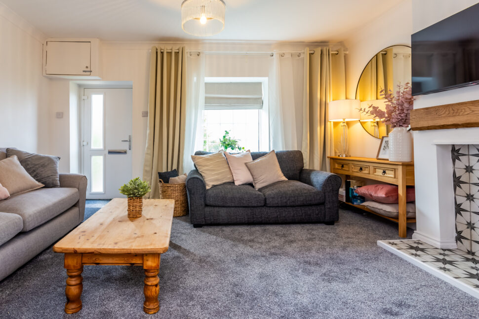 Traditional living room. Grey sofas & carpet. Oak furniture