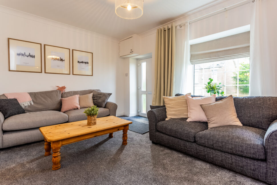 Traditional living room. Grey sofas & carpet. Oak furniture