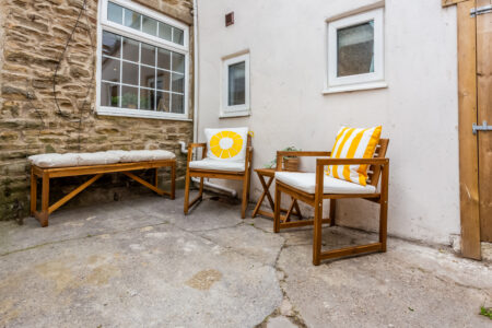 Garden patio area with outdoor wooden seating