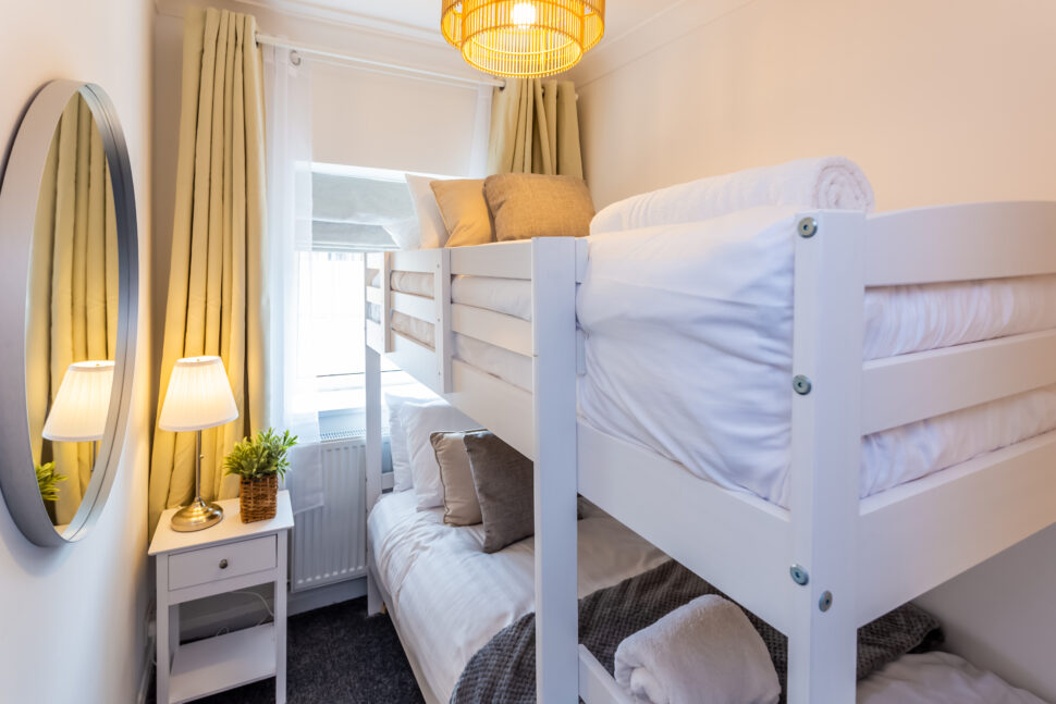 White bunk bed bedroom with grey and beige accessories