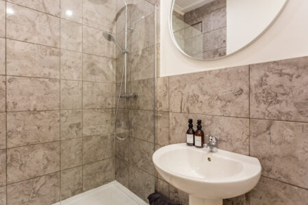 Beige tiled shower bathroom