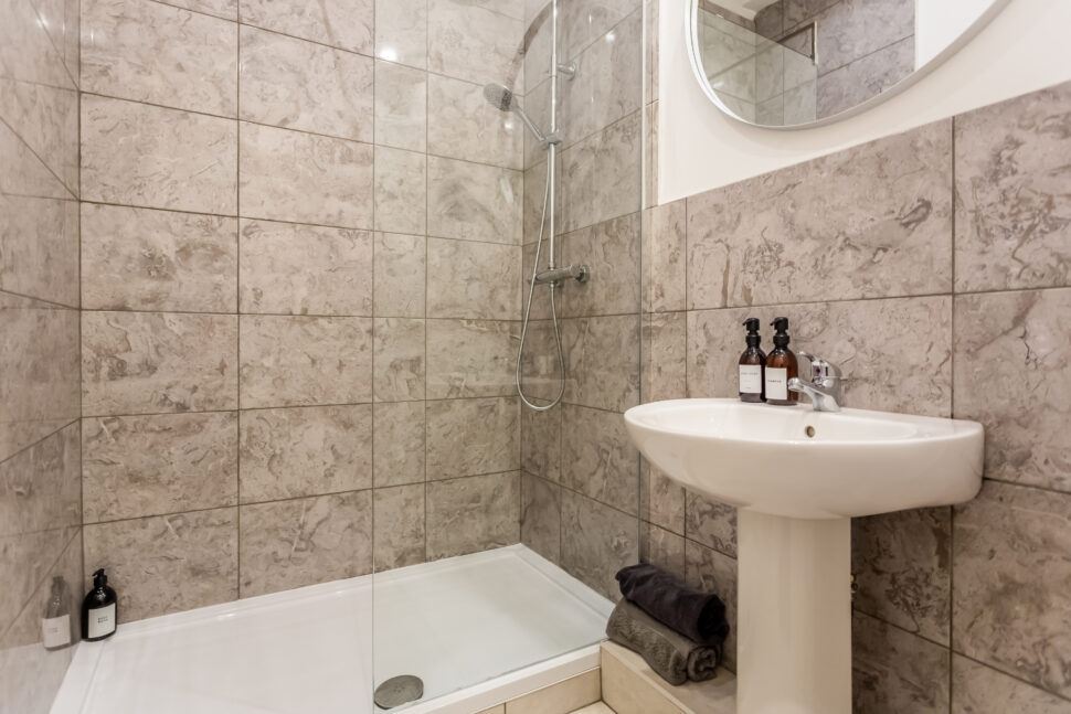 Beige tiled shower bathroom