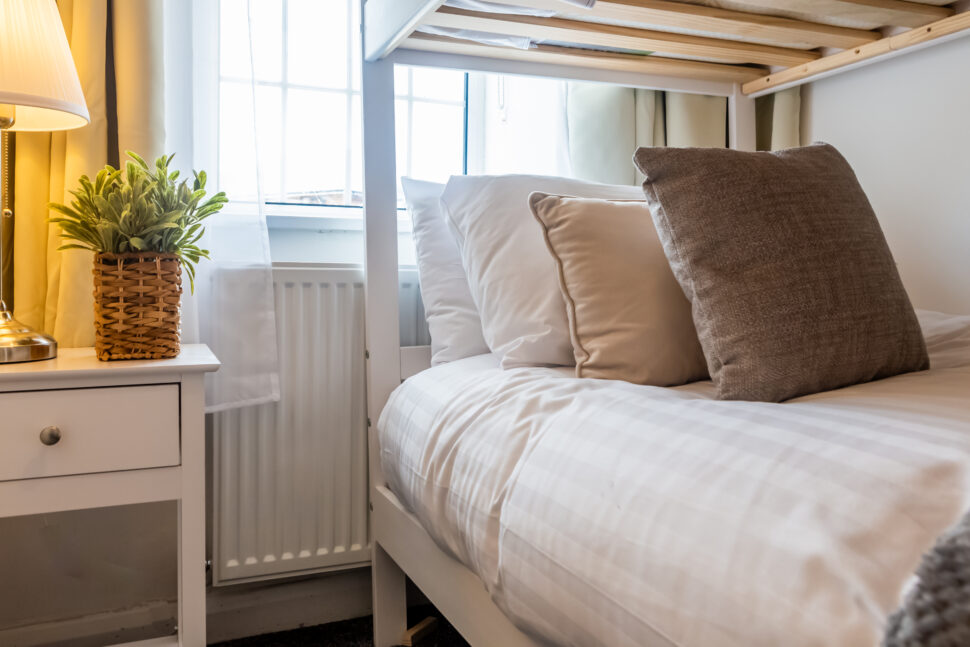 White bunk bed bedroom with grey and beige accessories