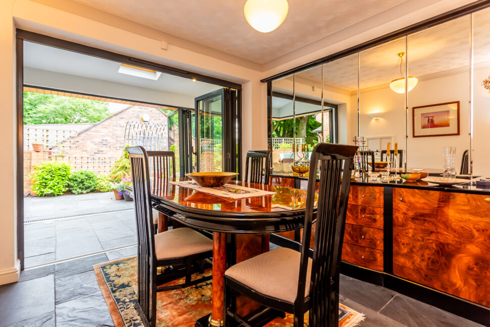 Dining room with oak furniture and mirrored wall