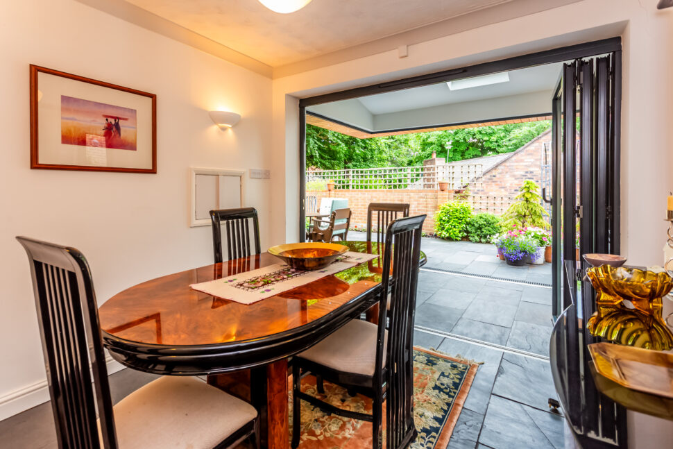 Dining room with oak furniture and mirrored wall