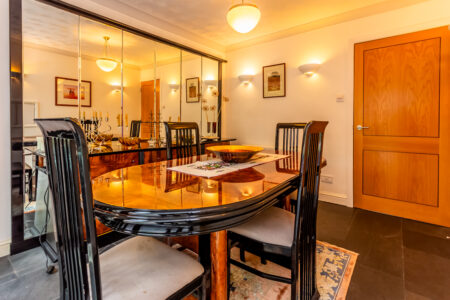 Dining room with oak furniture and mirrored wall