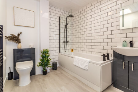 White shower bathroom with black accessories