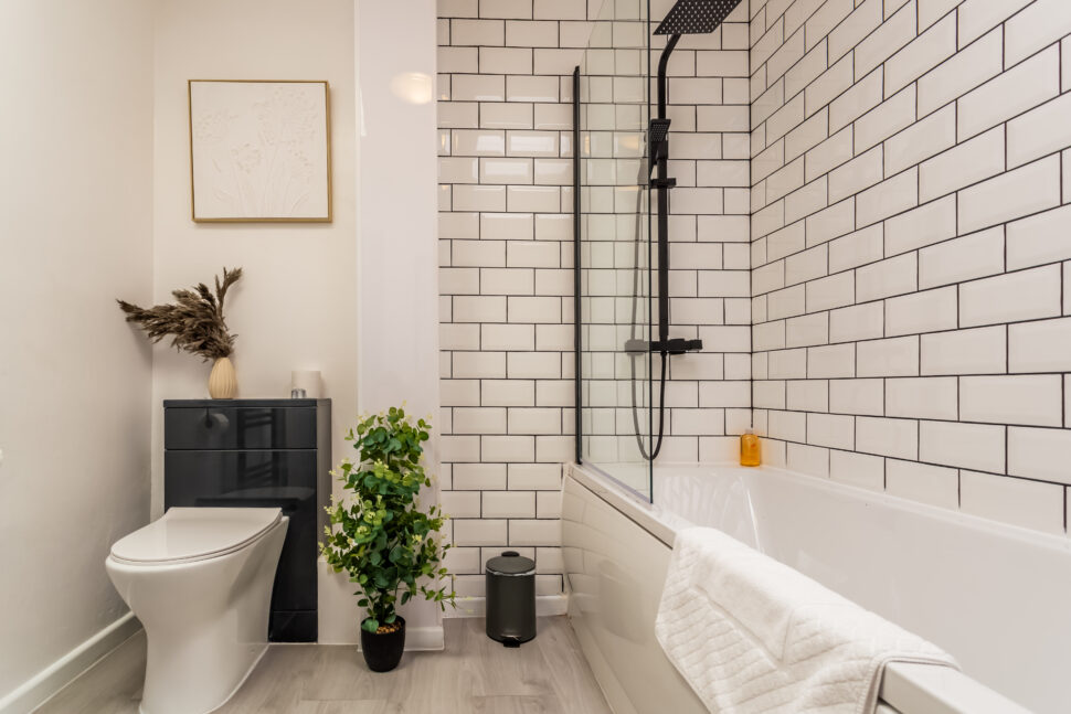 White shower bathroom with black accessories