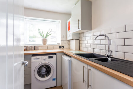 White u shaped kitchen with oak worktops