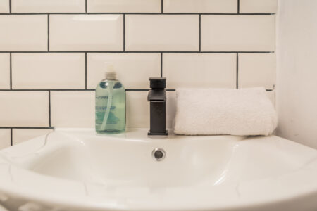 White shower bathroom with black accessories