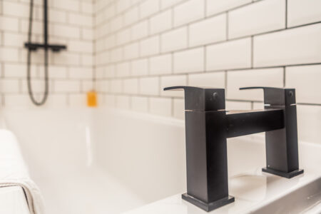 White shower bathroom with black accessories