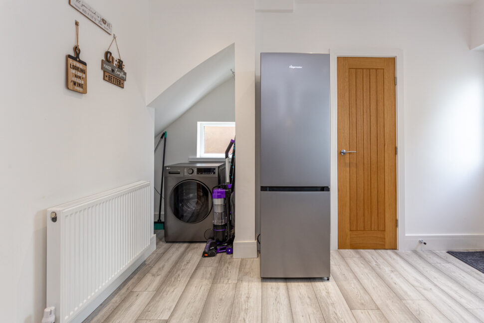 Grey u shaped kitchen with black worktops