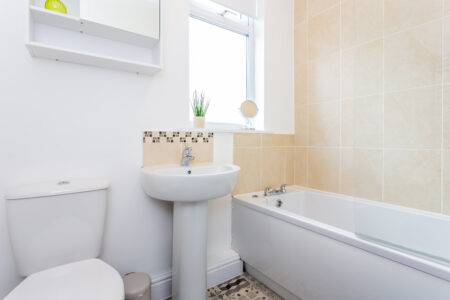 Beige tiled bathroom