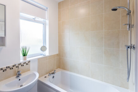 Beige tiled bathroom