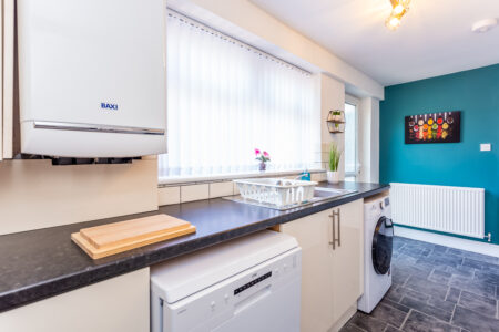 White galley kitchen with black worktops