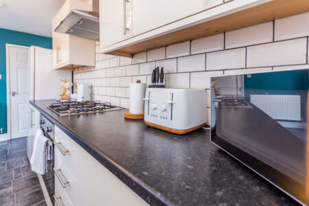 White galley kitchen with black worktops