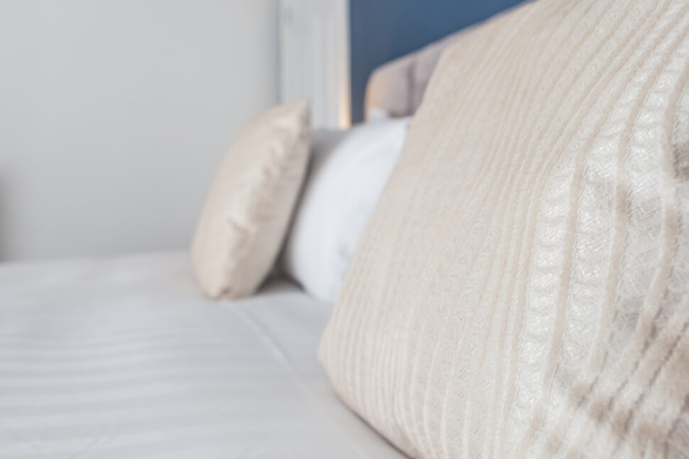 Navy king bedroom with grey accessories