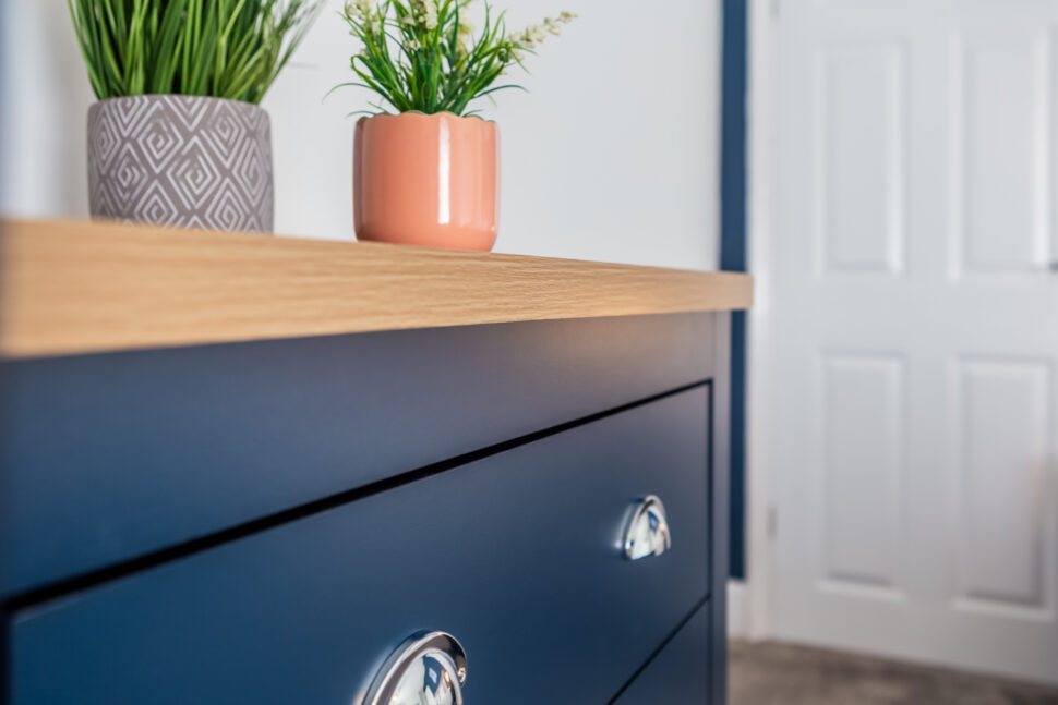 Navy king bedroom with grey accessories