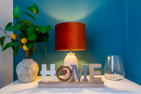 Green and blue dining room with orange accessories