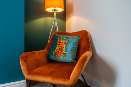 Green and blue dining room with orange accessories