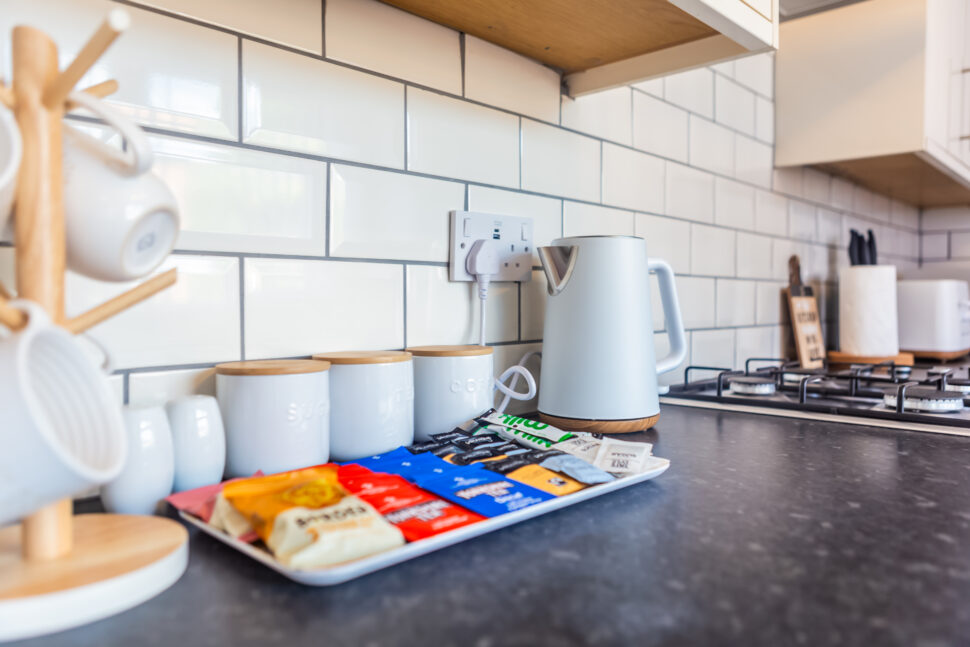 White galley kitchen with black worktops