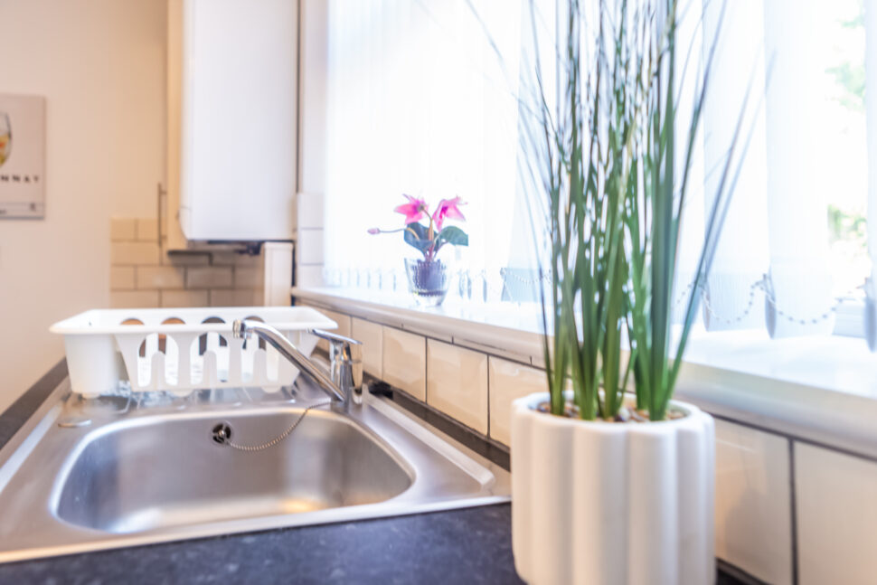 White galley kitchen with black worktops