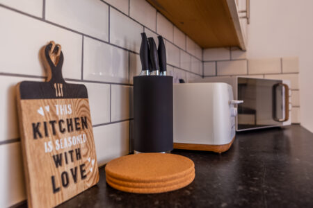 White galley kitchen with black worktops