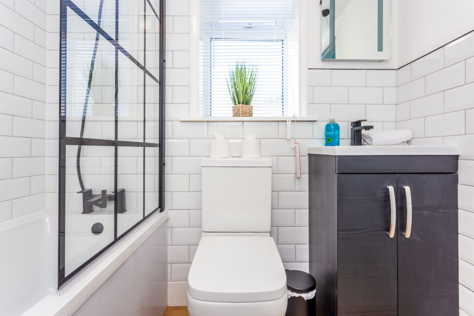 White bathroom with black accessoriesWhite bathroom with black accessories