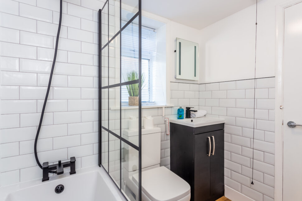 White bathroom with black accessories