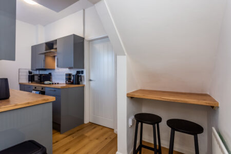 Off white galley kitchen. Grey kitchen with oak worktops