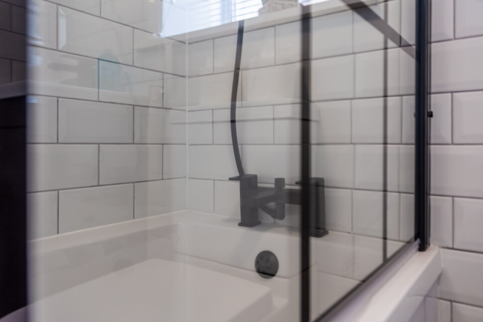 White bathroom with black accessories