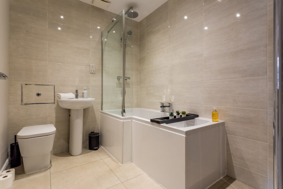 Beige tiled bath shower room