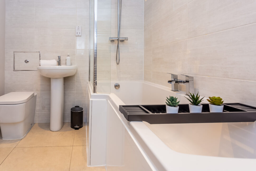 Beige tiled bath shower room