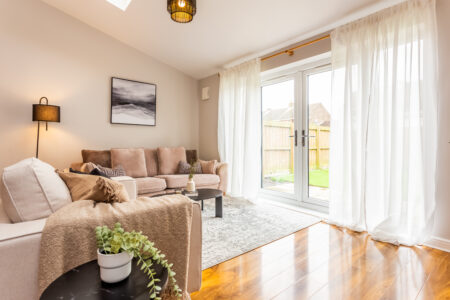 Beige living room with ammonite walls. Large rug