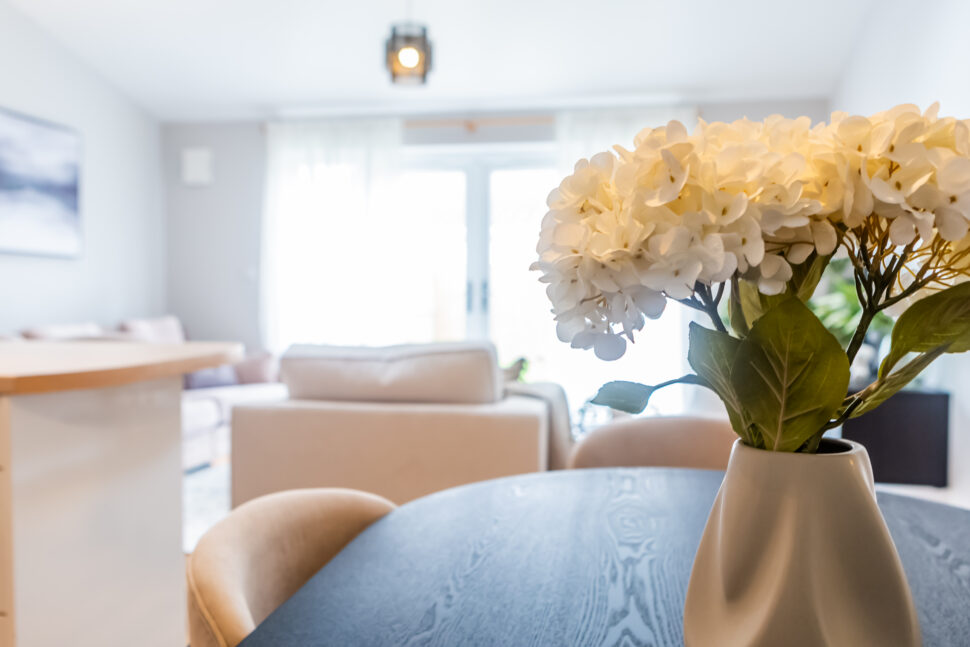 Beige living room. Black dining table. Beige dining chairs