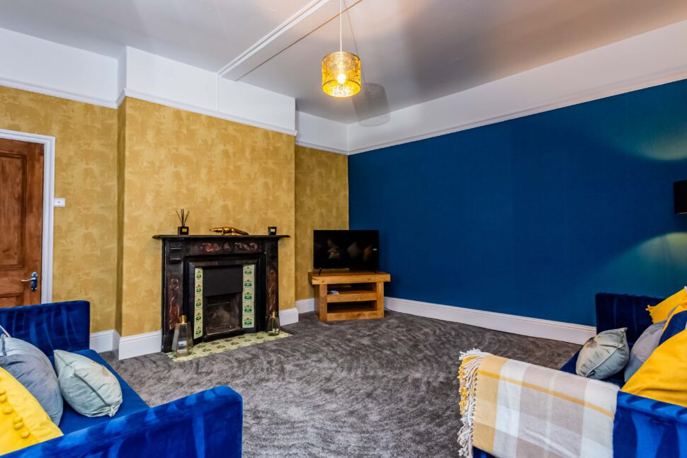 living room with blue sofas and fireplace