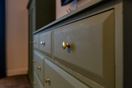 king bedroom with green chest of drawers