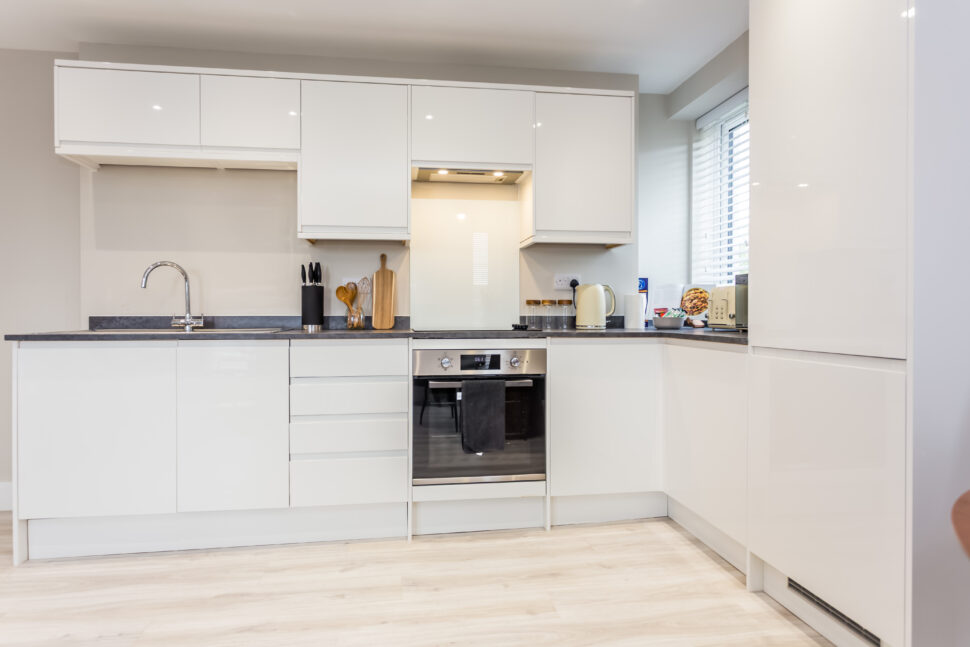 Toast Stays, showing clean, modern, white high-gloss kitchen units