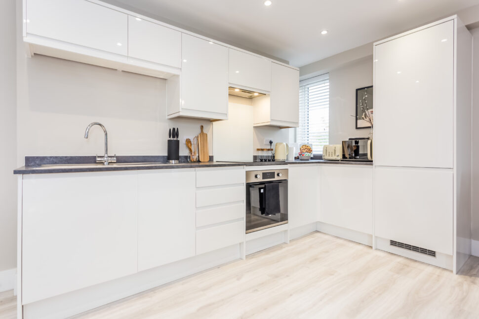 Toast Stays, showing clean, white high-gloss kitchen units